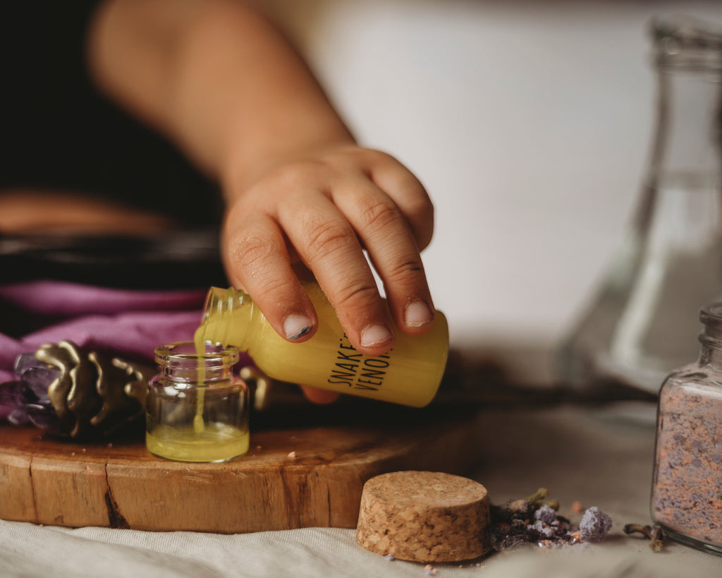 Snake Venom Liquid from Hocus Pocus potion kit  being poured into glass jar