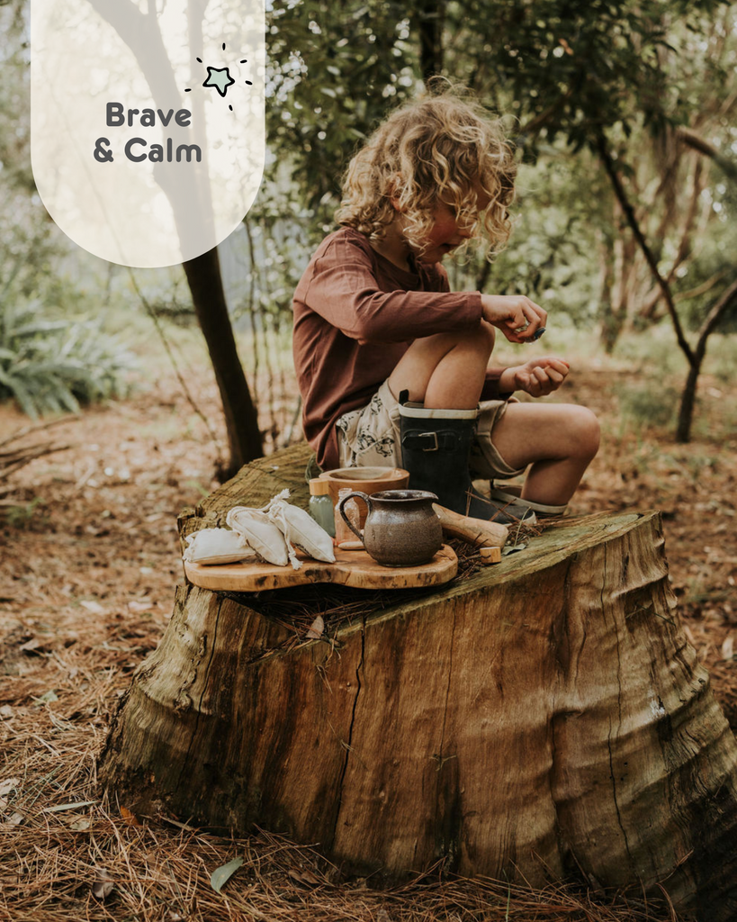 Wild adventure Potion kit. Image of a child sitting on a tree trunk with his potion set up. 