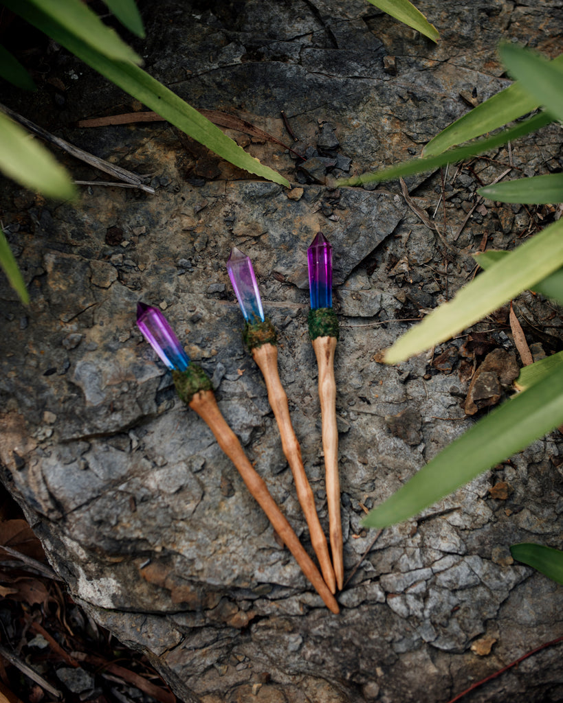 unicorn crystal resin wand with wooden handle and moss