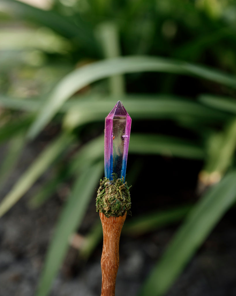 unicorn crystal resin wand with wooden handle and moss