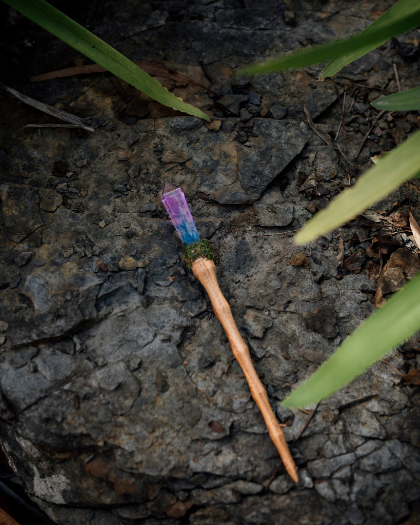unicorn crystal resin wand with wooden handle and moss