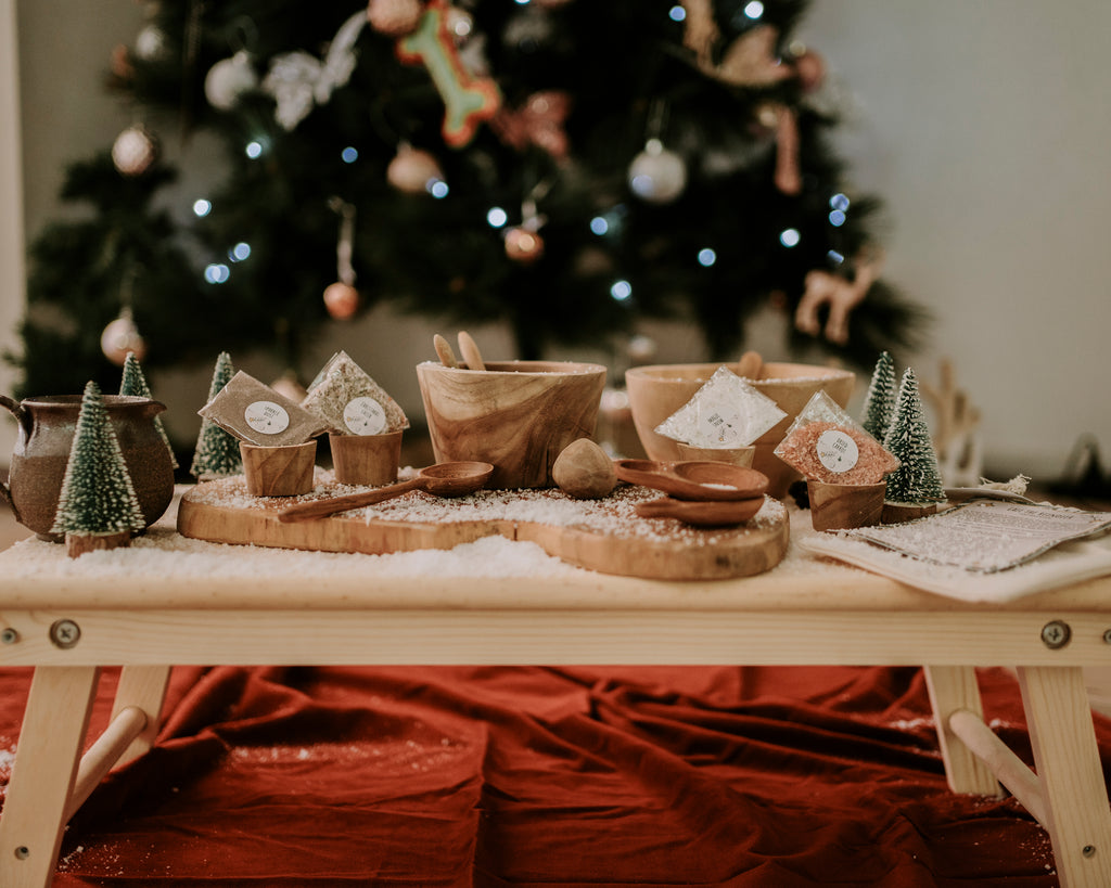 Christmas Eve Potion set up with wooden bowls and accessories and a christmas tree in the background